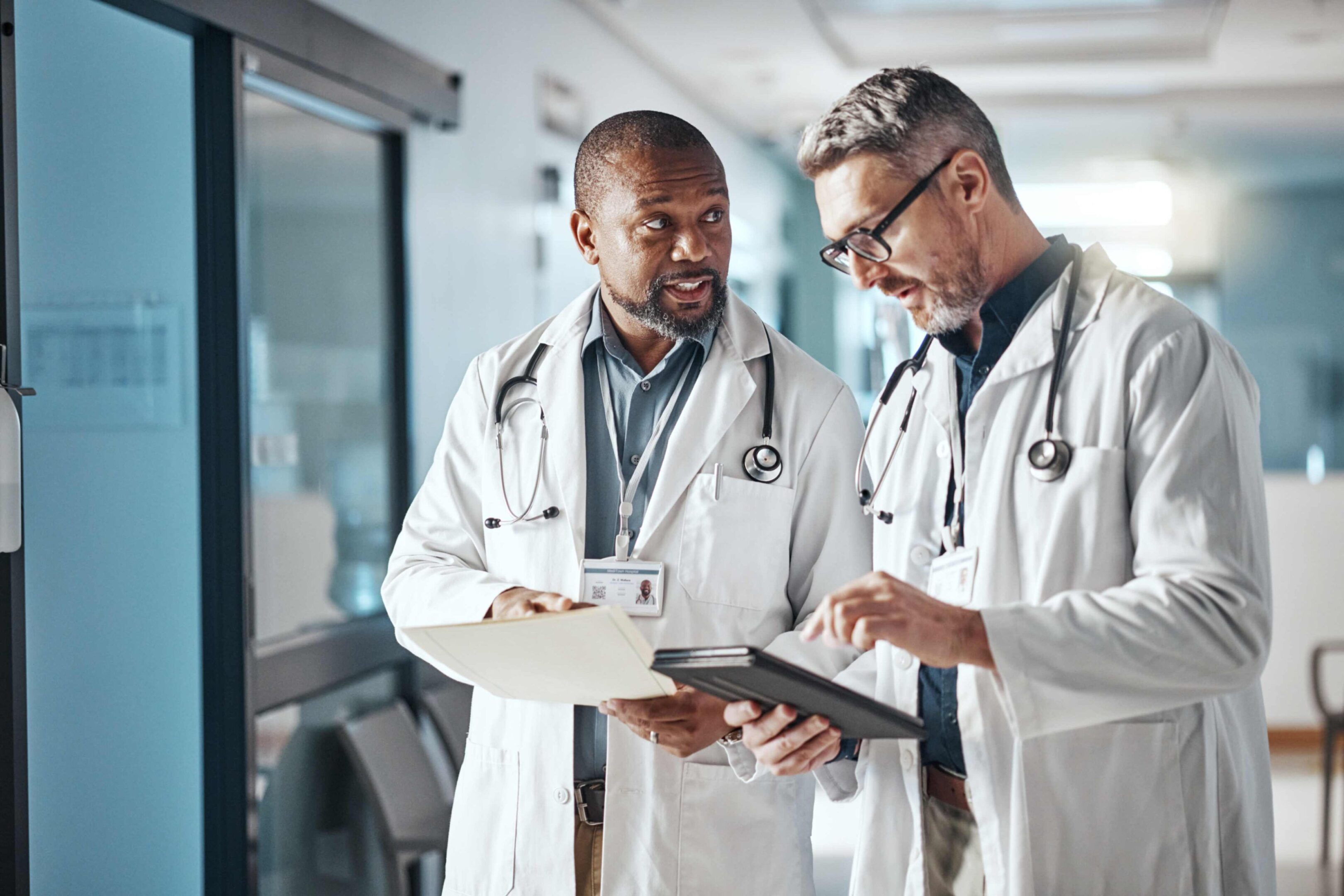Two doctors reviewing patient files together.