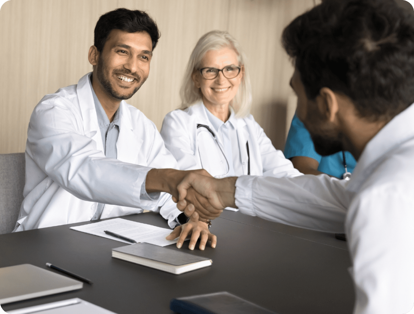 Doctors shaking hands, medical team meeting.